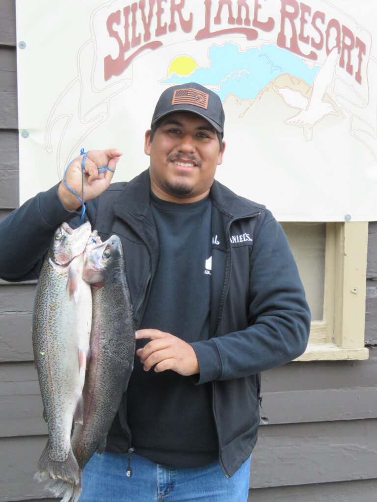 Richard Morales with a 6# 2oz and a 6# 4oz caught from a boat on Silver Lake using Garlic Power Bait